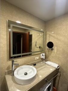 a bathroom with a sink and a mirror at Lovely studio by the sea with a terrace in Chakvi