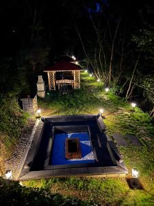 a garden at night with a gazebo at Willa FOLK Pieniny in Szczawnica
