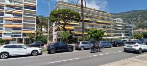 a group of cars and motorcycles parked on a city street at Casa Bella Vita in Menton