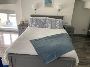 a bedroom with a large bed with two night stands at Anchor’s Away in Letterkenny