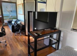 a living room with a flat screen tv on a table at ONE TRIP in Paysandú