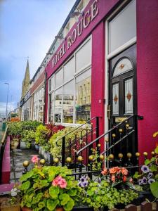 a pink building with flowers in front of it at Hotel LUX (Rouge) in Blackpool