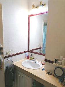 a bathroom with a sink and a large mirror at Callao Sun & Pool II in Callao Salvaje