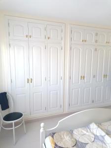 a white bedroom with white cabinets and a bed at Callao Sun & Pool II in Callao Salvaje