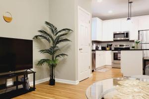 a living room with a table and a palm tree at 2 bd 2 bath in Fountain Square- 5 Min to Downtown in Indianapolis