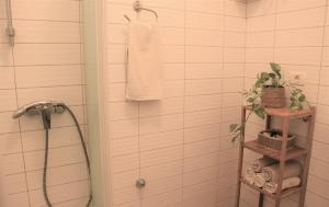 a bathroom with a shower and a towel at Apartments Fink in Portorož
