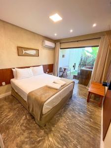 a bedroom with a large bed and a large window at Pousada Noah Noah in São Miguel dos Milagres