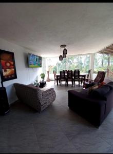 a living room with a couch and a table at Finca de recreo Claro de Luna in Copacabana