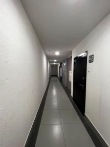 a hallway with a long corridor with a door at casa langa magazine in Floreşti