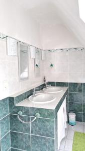 a bathroom with two sinks and a mirror at Maison de 4 chambres avec jardin clos et wifi a Tregomeur a 8 km de la plage in Trégomeur