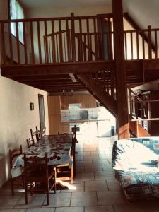 a dining room with a table and chairs and a staircase at Gîte, Sexey-Aux-Forges, 8 personnes, 180m², 4 chambres 