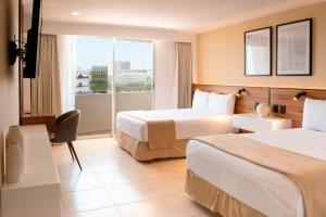 Postel nebo postele na pokoji v ubytování Hotel Calypso Cancun