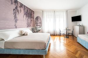 een slaapkamer met een bed en een woonkamer bij Villa Bonafata b&b in Trieste