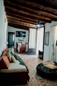 a bedroom with a large bed and a dining room at Huaco Casa de Campo in Belén