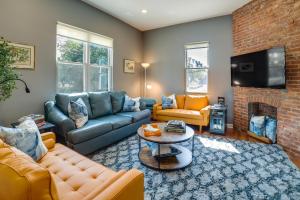 a living room with a couch and a fireplace at Family-Friendly Pittsburgh Home about 4 Mi to Downtown in Pittsburgh