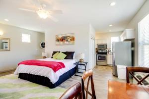a bedroom with a large bed and a kitchen at Albuquerque Vacation Rental Less Than 1 Mi to Downtown! in Albuquerque