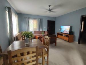 a living room with a dining table and a television at Casa Aguila in San Juan del Sur