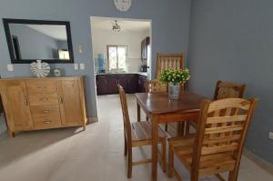 a kitchen and dining room with a table and chairs at Casa Aguila in San Juan del Sur