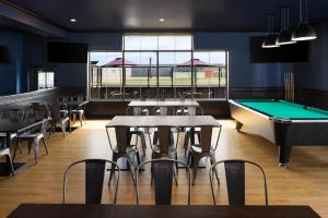 a restaurant with tables and a pool table at Four Points by Sheraton Edmonton South in Edmonton