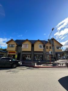 a house with a car parked in front of it at Los Alerces Patagonia Apart in Esquel