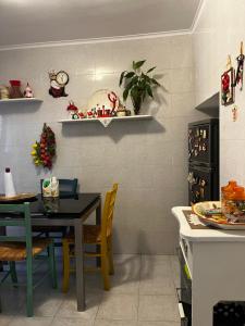a kitchen with a table and a dining room at Casa Verde in Mesagne