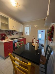 a kitchen with a table and chairs in a kitchen at Casa Verde in Mesagne +11 photos