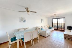 a living room with a table and a couch at Roda, Sea and Golf in Roda