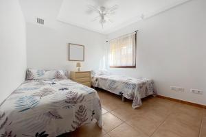 a bedroom with two beds and a window at Roda, Sea and Golf in Roda +12 photos