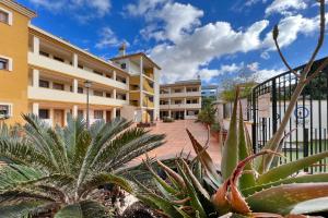 a courtyard of a building with a bunch of plants at Roda, Sea and Golf in Roda
