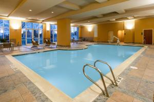 a large swimming pool in a hotel lobby at Embassy Suites by Hilton Portland Airport in Portland