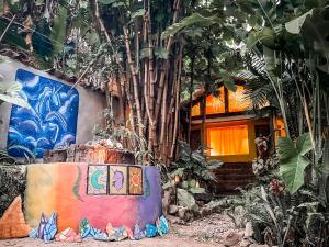a house with a painting on the side of it at Unicorn Reborn - Peaceful Rentals in San Marcos La Laguna