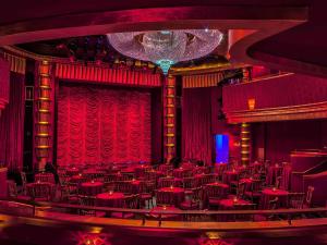 a theatre with red chairs and a red curtain at Faena Hotel Miami Beach in Miami Beach
