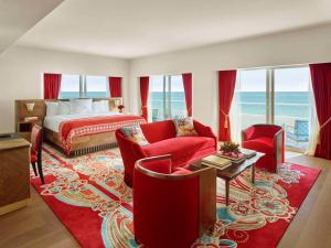 a hotel room with a bed and a red rug at Faena Hotel Miami Beach in Miami Beach
