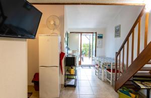 a living room with a refrigerator and a tv at Maison conviviale à Argelès-sur-Mer avec piscine partagee 35 m² in Argelès-sur-Mer