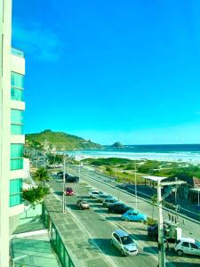 a view of the beach from the balcony of a building at APARTAMENTO SOPHIA I - ORLA da PRAIA GRANDE in Arraial do Cabo