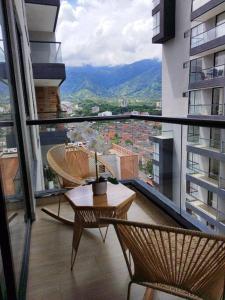 a balcony with chairs and a table on a building at SuiteGreen, exclusivo apartaestudio !! in Ibagué