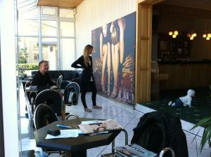 a woman standing in a restaurant talking to a man at Du Broliai Hotel in Palanga