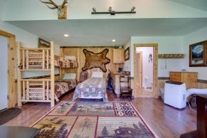 a bedroom with two bunk beds and a desk at Cozy Countryside Cabin in Robie Creek Park! in Boise