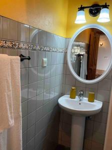 a bathroom with a sink and a mirror at Casa do Laureano in Santo Amaro