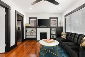 a living room with a couch and a fireplace at Craftsman Bungalow- University Heights 2BR Home in San Diego