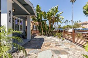 a house with a porch with a fence at Craftsman Bungalow- University Heights 2BR Home in San Diego