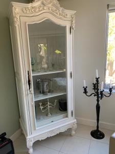 an ornate white cabinet in a room at Koombana Escape in Perth