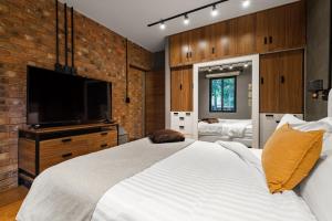 a bedroom with a large bed and a flat screen tv at Condesa Square by RentinBA in Mexico City