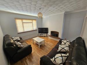 a living room with a couch and a table at 3 bedroom Semi detached in Erith