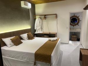 a bedroom with a large white bed in a room at Kanui Mar (cobertura garden) in São Miguel dos Milagres