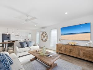a living room with a couch and a table at Beach City 3 Bedroom Modern Townhouse in Maroochydore