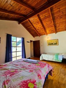 a bedroom with a large bed and a window at La joyita in Ituzaingó