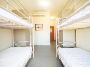 two bunk beds in a room with a hallway at YHA Brisbane City in Brisbane