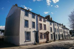 un grand bâtiment blanc sur le côté d'une rue dans l'établissement The Georgian Townhouse - 4 Bed House, à Whitehaven