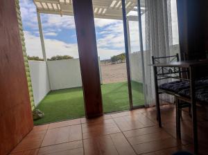 a room with a view of the beach from a window at Cabaña2 Punta de Choros in Choros